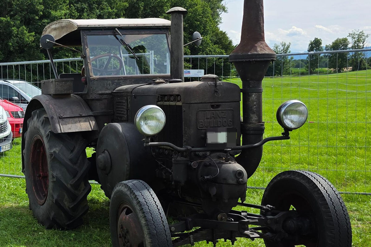 Ein Lanz Bulldog D8506 steht auf einer Wiese.
