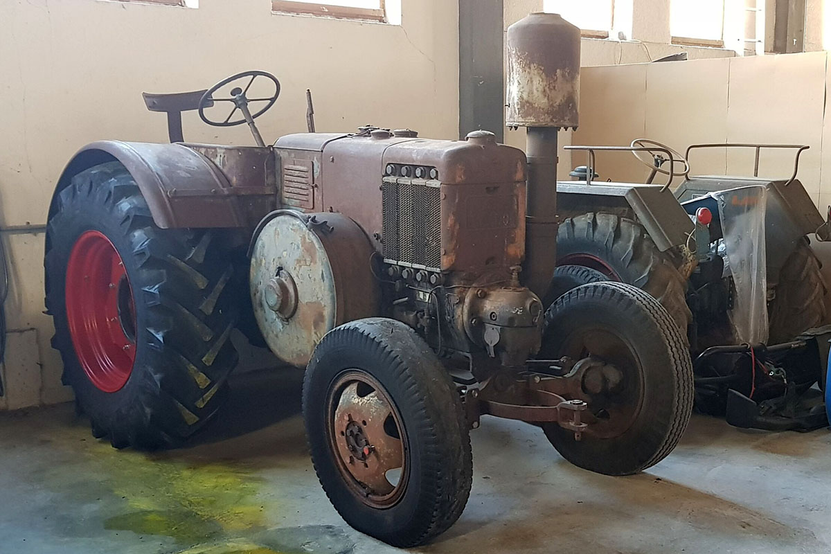 Ein Lanz D8506 in Patina steht in einer Garage.